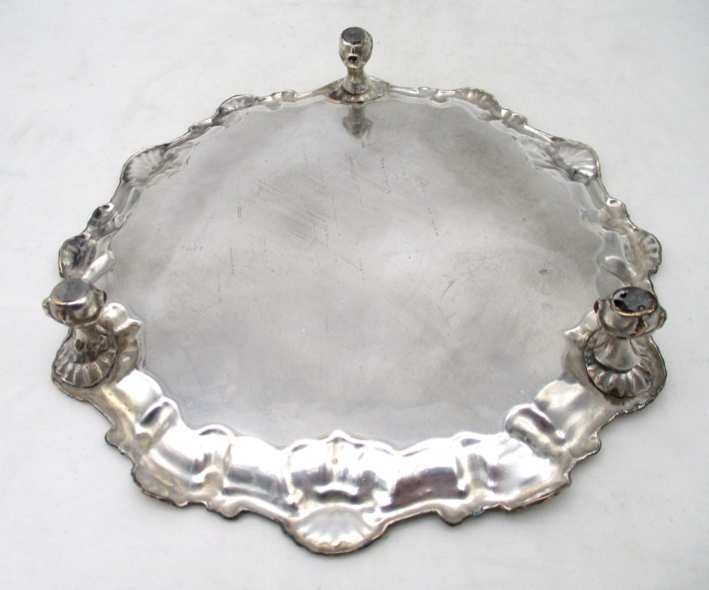 A pair of circular 18th-century Old Sheffield plated card trays with shell borders, heraldic crest engravings, and small scroll feet. View IX