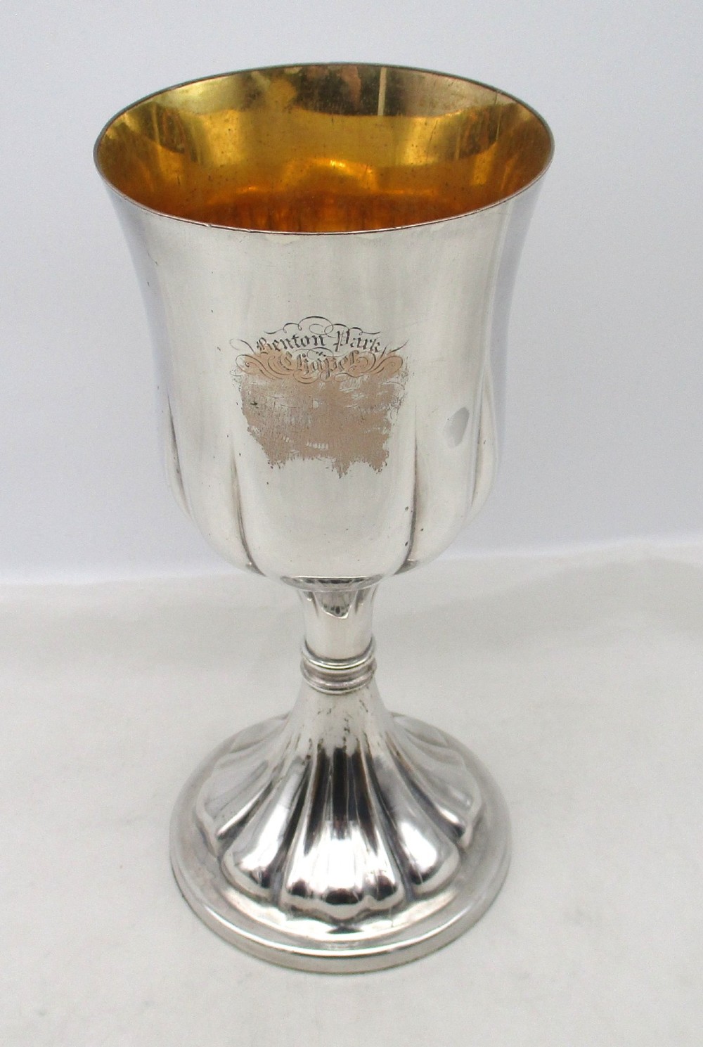 A pair of silver-plated Old Sheffield chalices featuring fluted lower bowls, raised lobed bases, and gilded interiors engraved with chapel inscriptions. View VI
