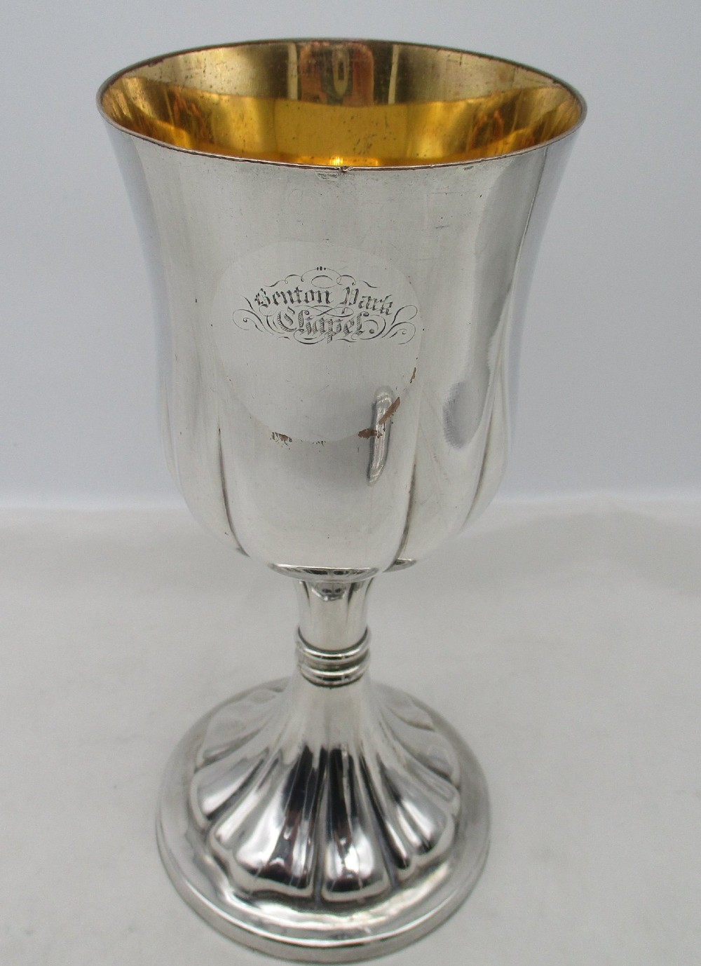 A pair of silver-plated Old Sheffield chalices featuring fluted lower bowls, raised lobed bases, and gilded interiors engraved with chapel inscriptions. View VII