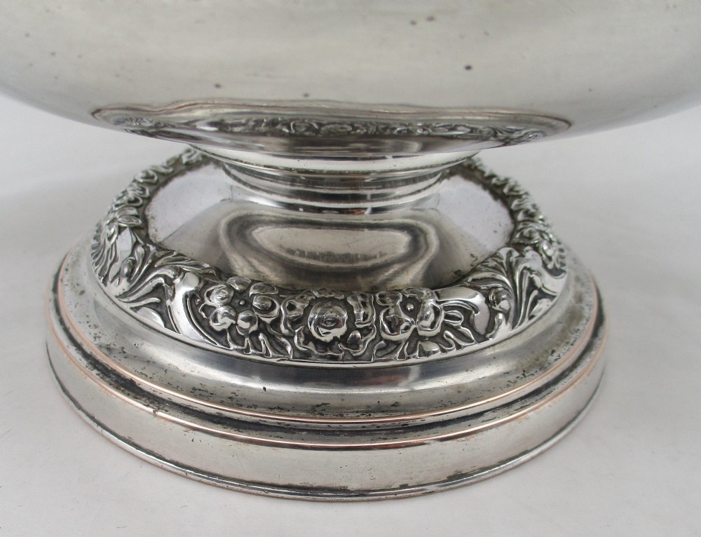 A Georgian silver-plated double-handled wine cooler featuring an engraved family crest, foliage borders, and a pedestal base. View VII