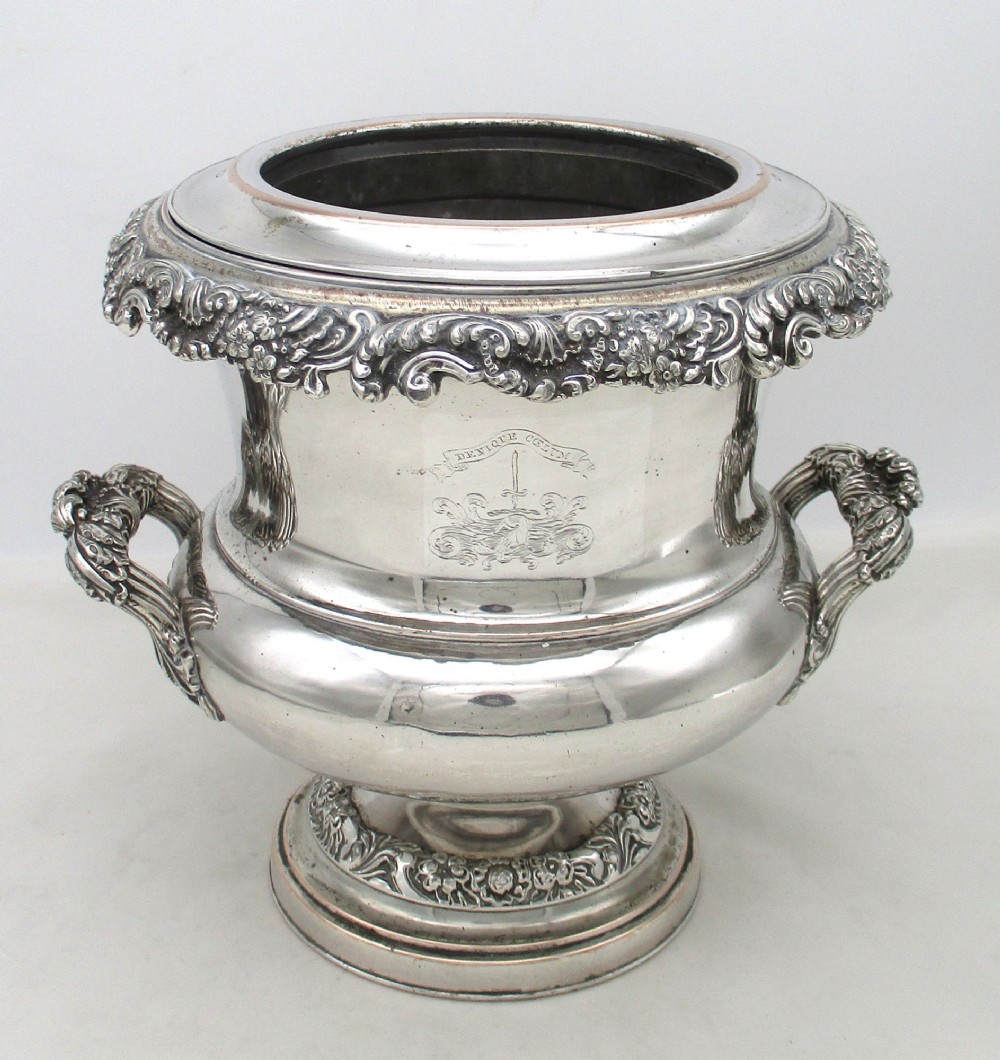 A Georgian silver-plated double-handled wine cooler featuring an engraved family crest, foliage borders, and a pedestal base. View XV