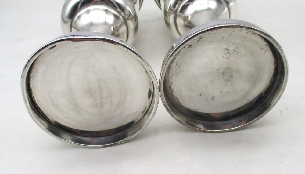 A pair of tall silver-plated church chalices featuring flared rims, knopped central stems, and stepped circular bases. View VIII