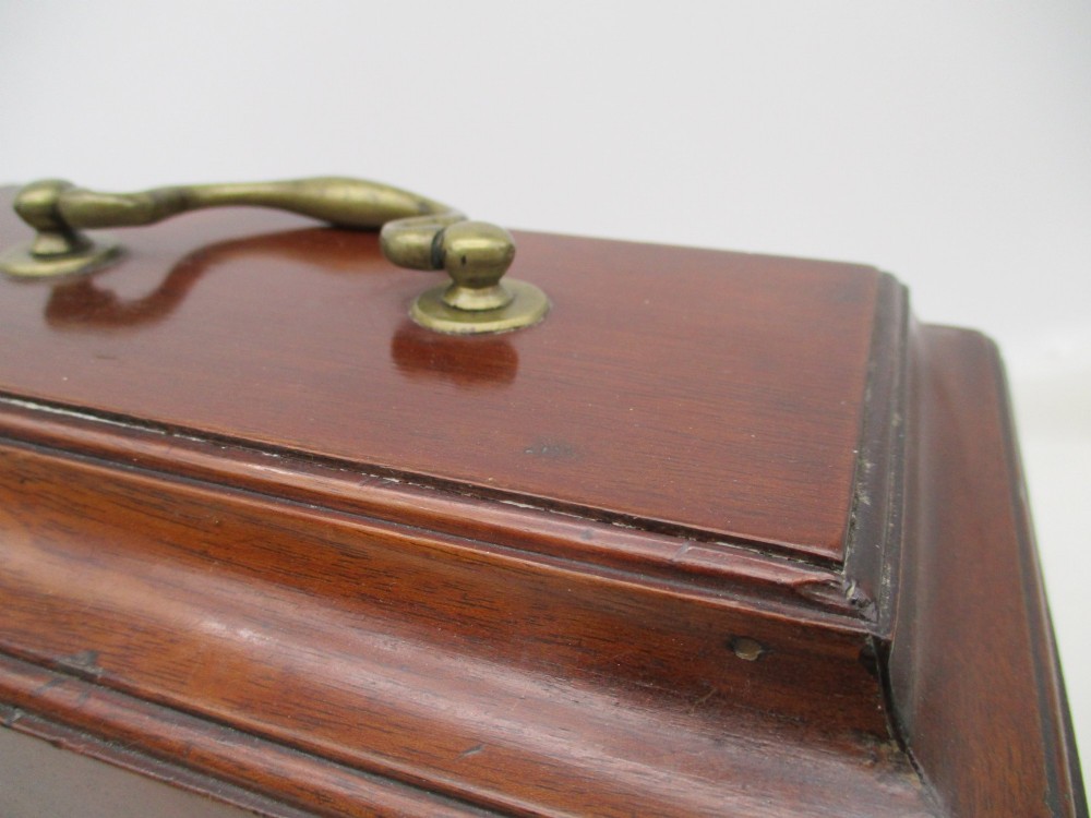 A rectangular George III mahogany tea caddy featuring a stepped hinged lid, a brass swan-neck handle, and a pierced brass keyhole escutcheon. View V