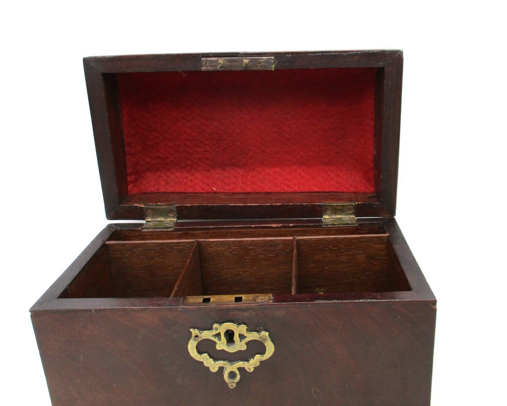 A rectangular George III mahogany tea caddy featuring a stepped hinged lid, a brass swan-neck handle, and a pierced brass keyhole escutcheon. View VI