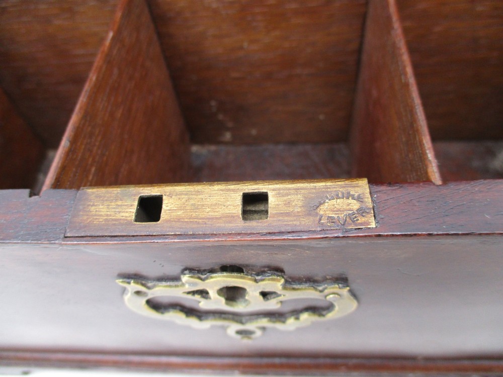 A rectangular George III mahogany tea caddy featuring a stepped hinged lid, a brass swan-neck handle, and a pierced brass keyhole escutcheon. View VIII