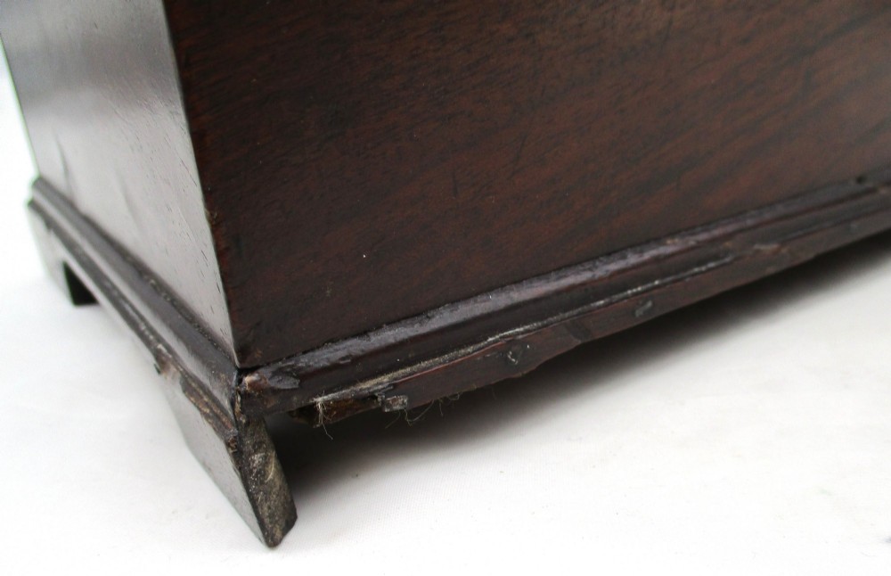 A rectangular George III mahogany tea caddy featuring a stepped hinged lid, a brass swan-neck handle, and a pierced brass keyhole escutcheon. View IX