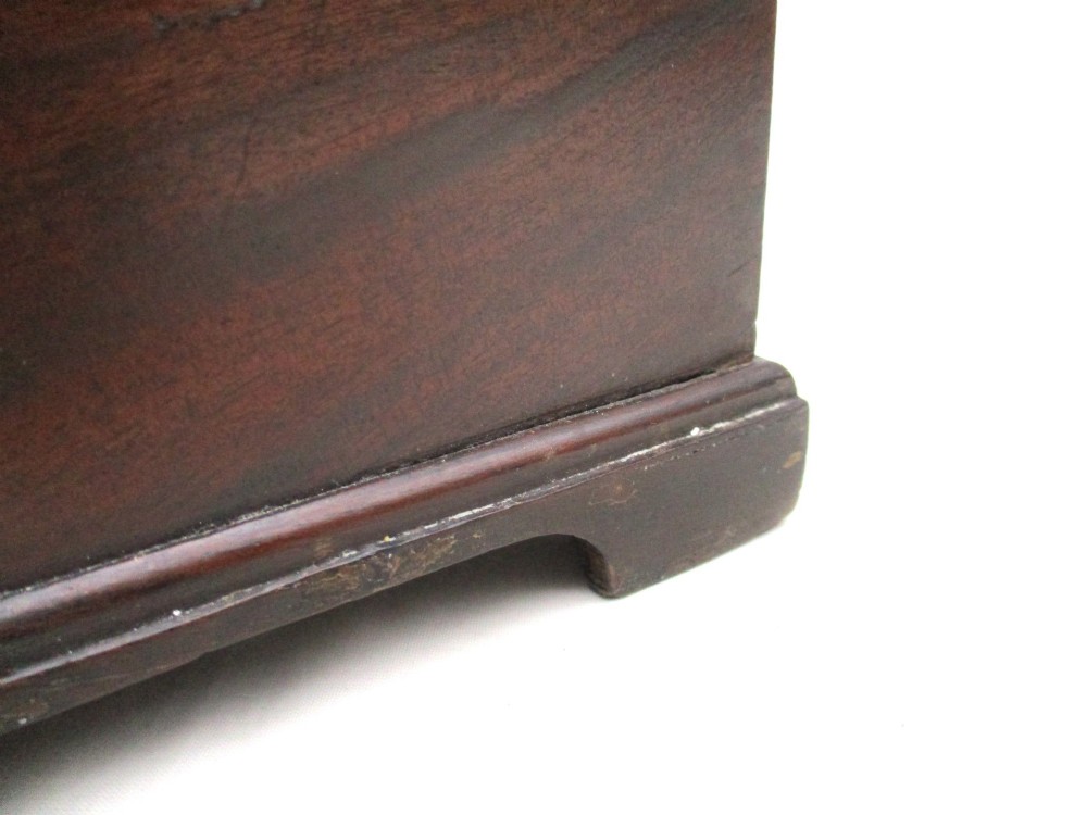 A rectangular George III mahogany tea caddy featuring a stepped hinged lid, a brass swan-neck handle, and a pierced brass keyhole escutcheon. View X