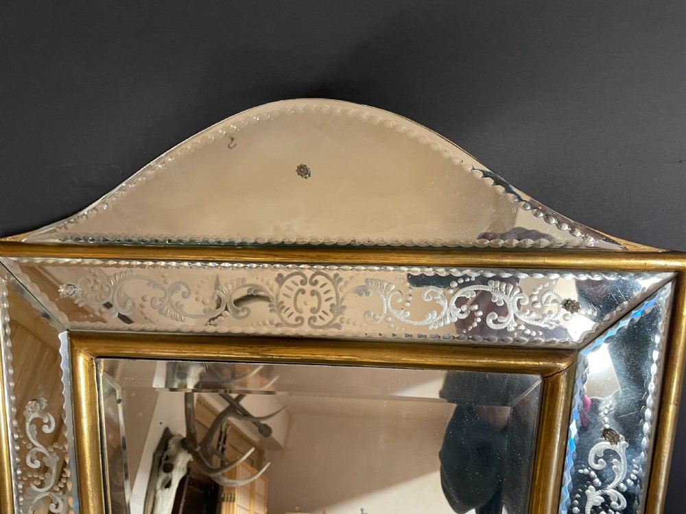 A rectangular Italian Venetian style wall mirror featuring etched glass floral borders, a gilt wood inner frame, and scalloped top and bottom mirrored extensions. View II