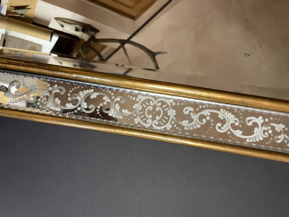 A rectangular Italian Venetian style wall mirror featuring etched glass floral borders, a gilt wood inner frame, and scalloped top and bottom mirrored extensions. View IV
