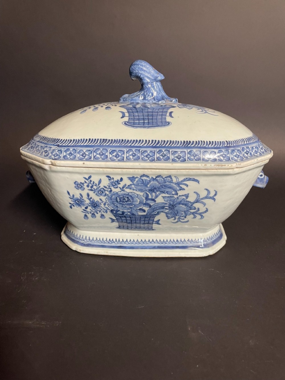 An antique blue and white Chinese export porcelain soup tureen and lid decorated with hand-painted floral motifs and geometric borders.
