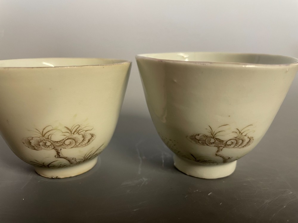 A pair of handleless Chinese export porcelain tea cups featuring hand-painted sepia greyhounds against an off-white ground. View V