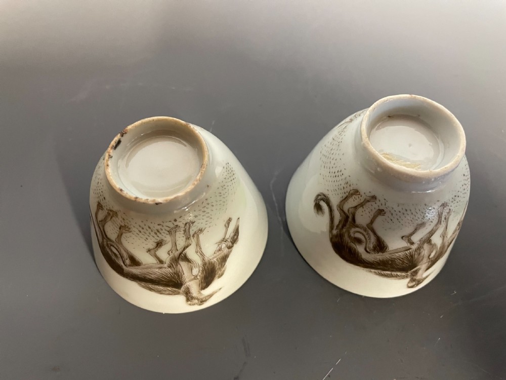 A pair of handleless Chinese export porcelain tea cups featuring hand-painted sepia greyhounds against an off-white ground. View VIII