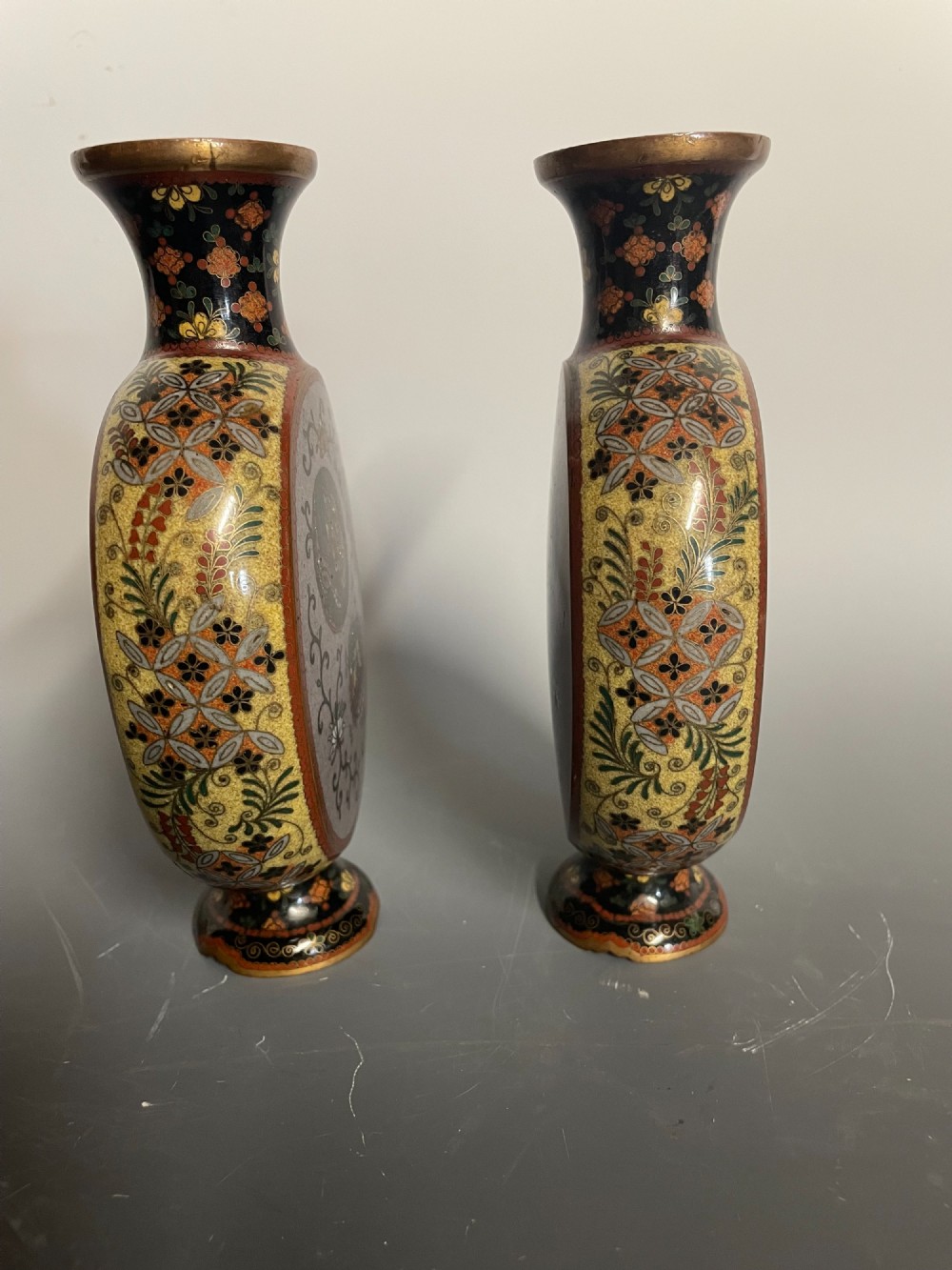A pair of Japanese cloisonne enamel moon-flask vases featuring dragon medallions and floral scrollwork on flared bases. View II