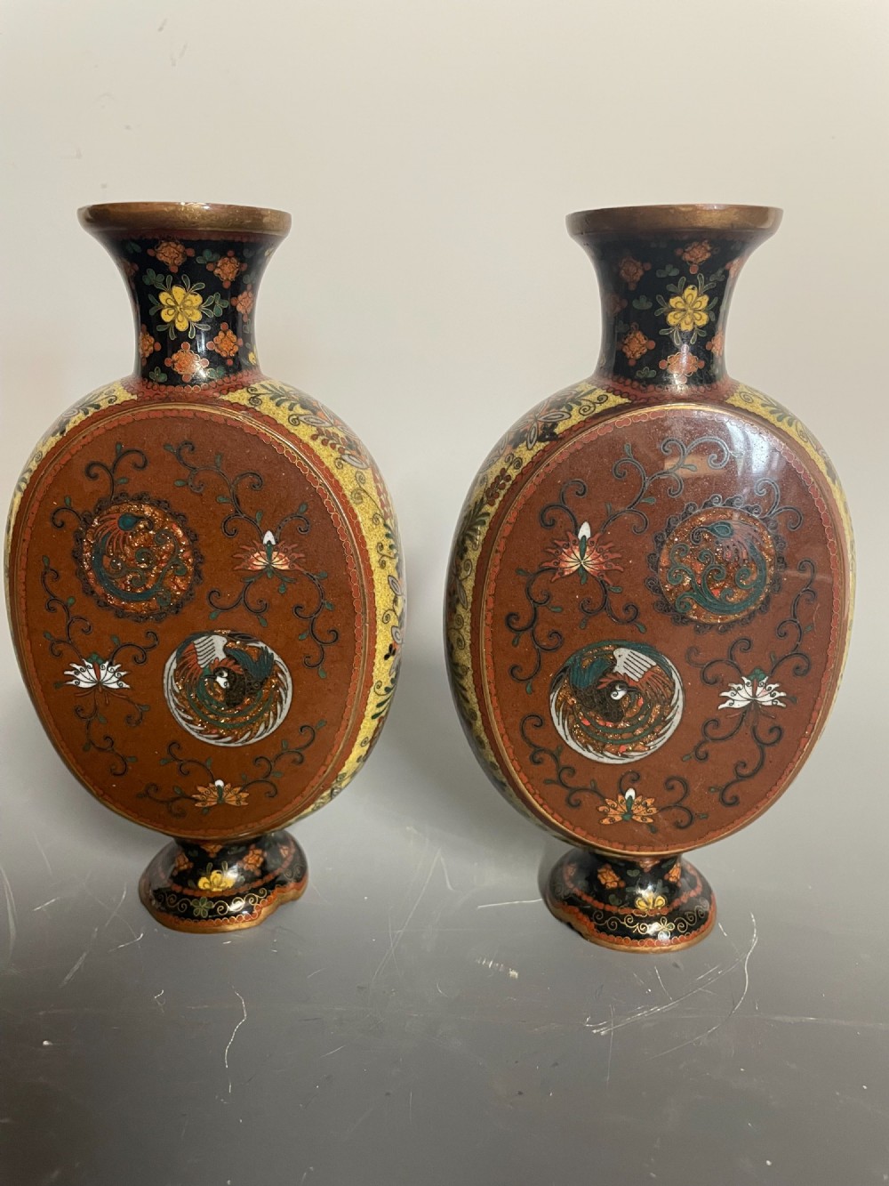 A pair of Japanese cloisonne enamel moon-flask vases featuring dragon medallions and floral scrollwork on flared bases. View IV