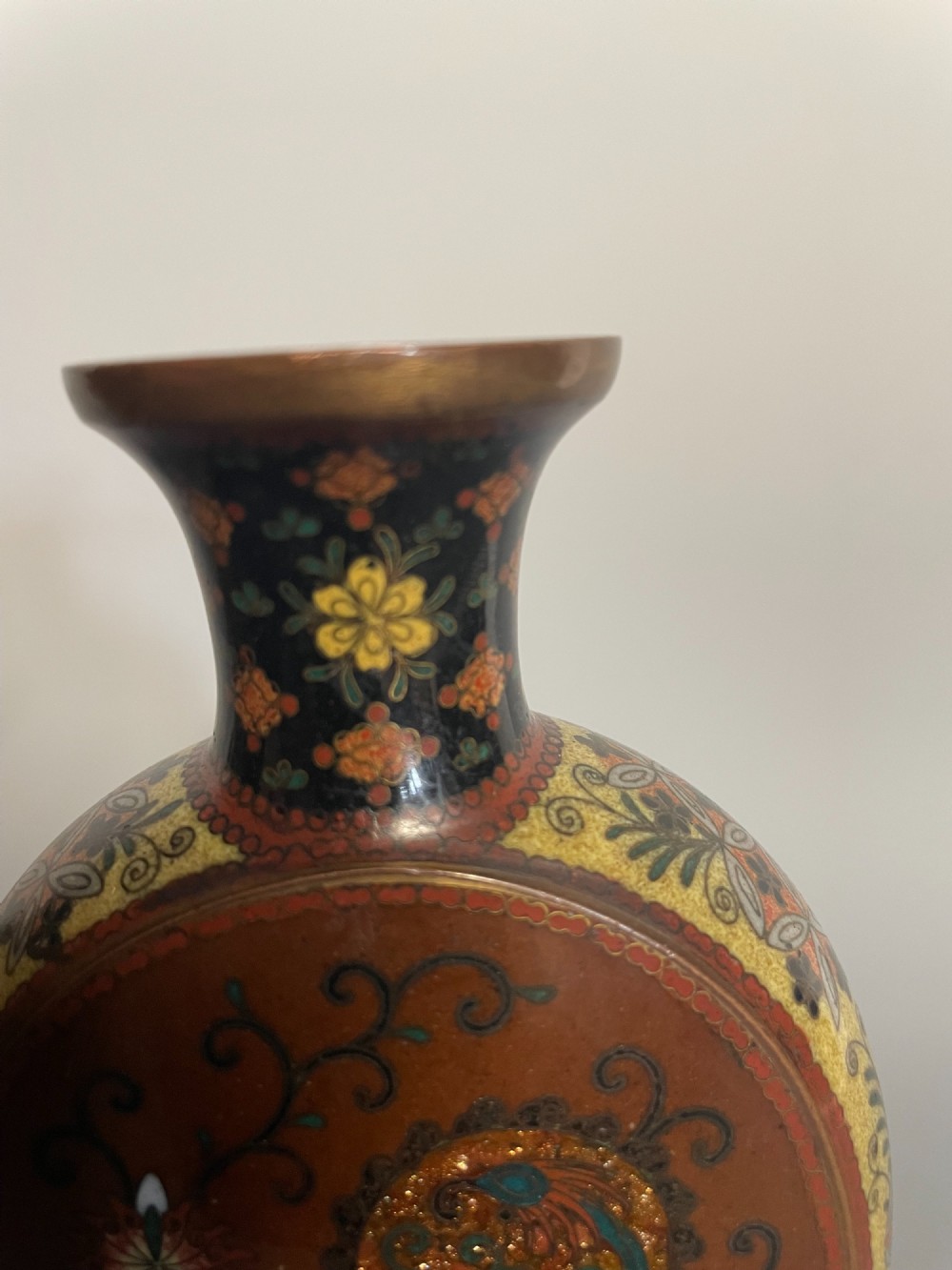 A pair of Japanese cloisonne enamel moon-flask vases featuring dragon medallions and floral scrollwork on flared bases. View V