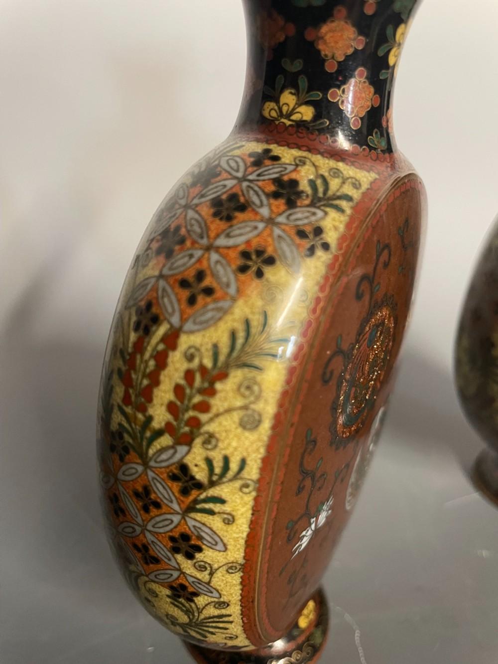 A pair of Japanese cloisonne enamel moon-flask vases featuring dragon medallions and floral scrollwork on flared bases. View VI