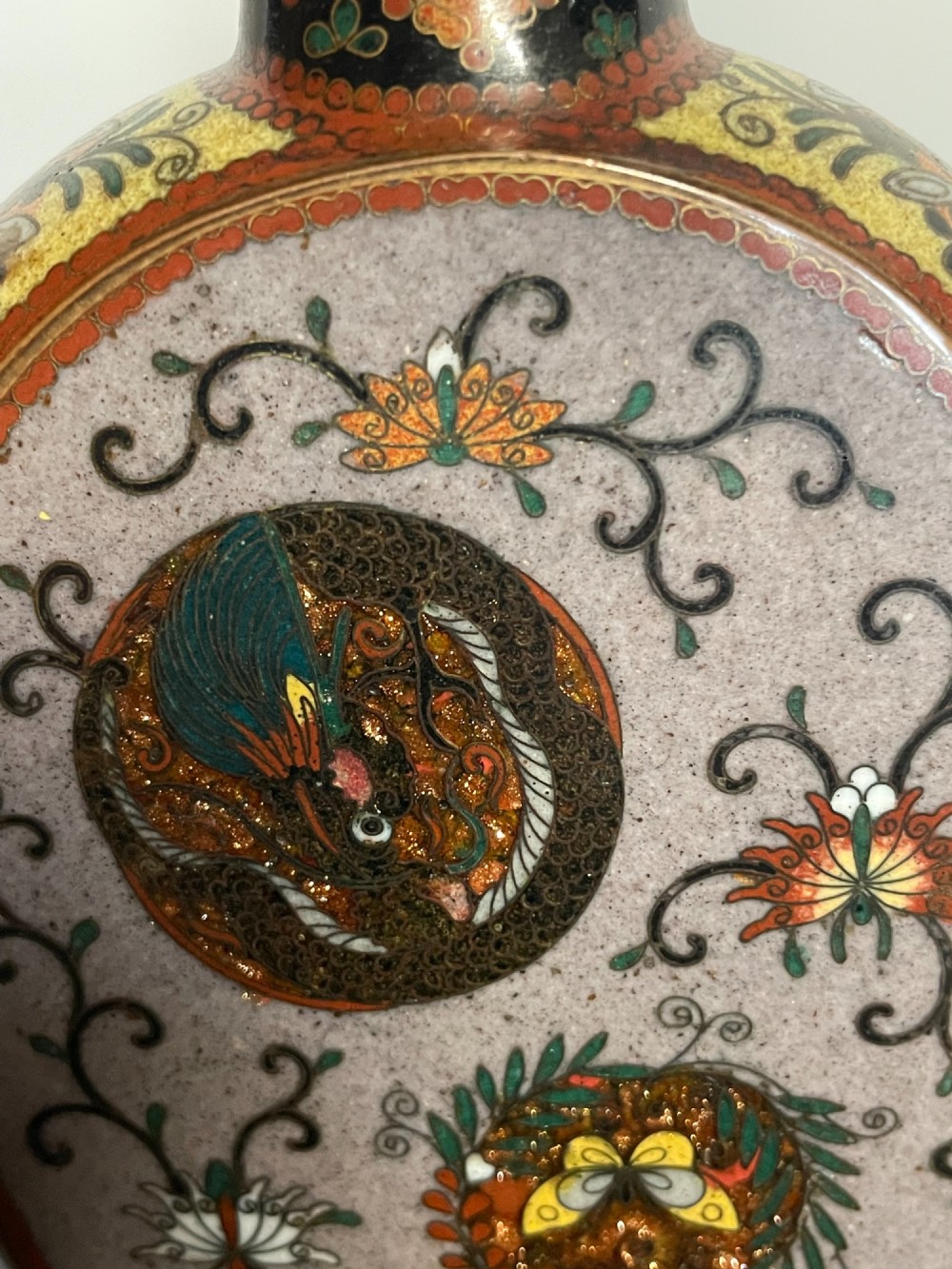 A pair of Japanese cloisonne enamel moon-flask vases featuring dragon medallions and floral scrollwork on flared bases. View VIII