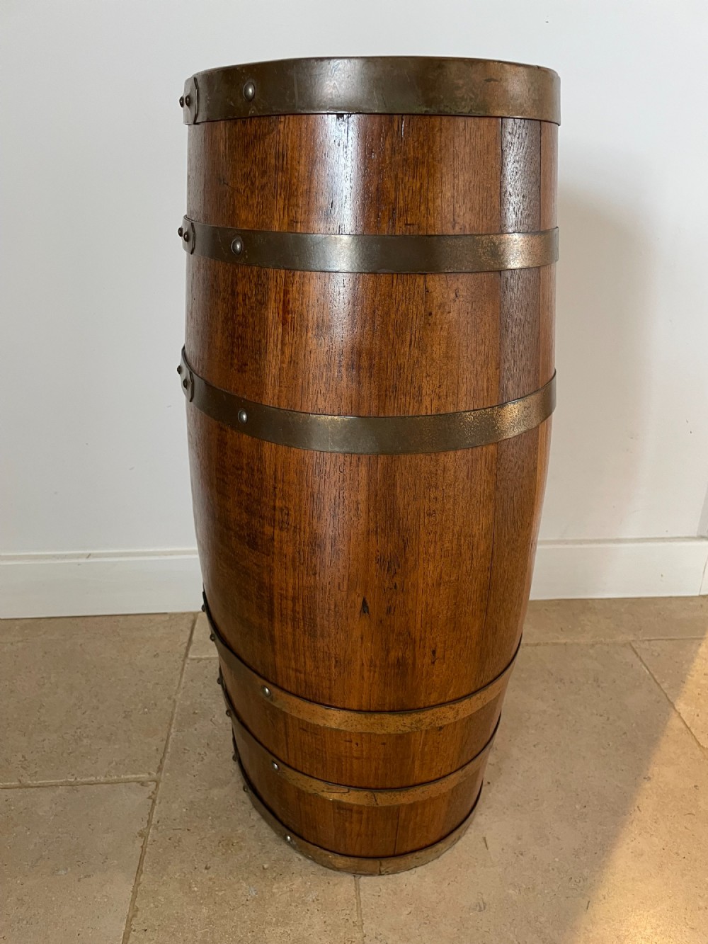 A barrel-shaped coopered oak umbrella stand featuring riveted metal bands and a central top divider. View IV