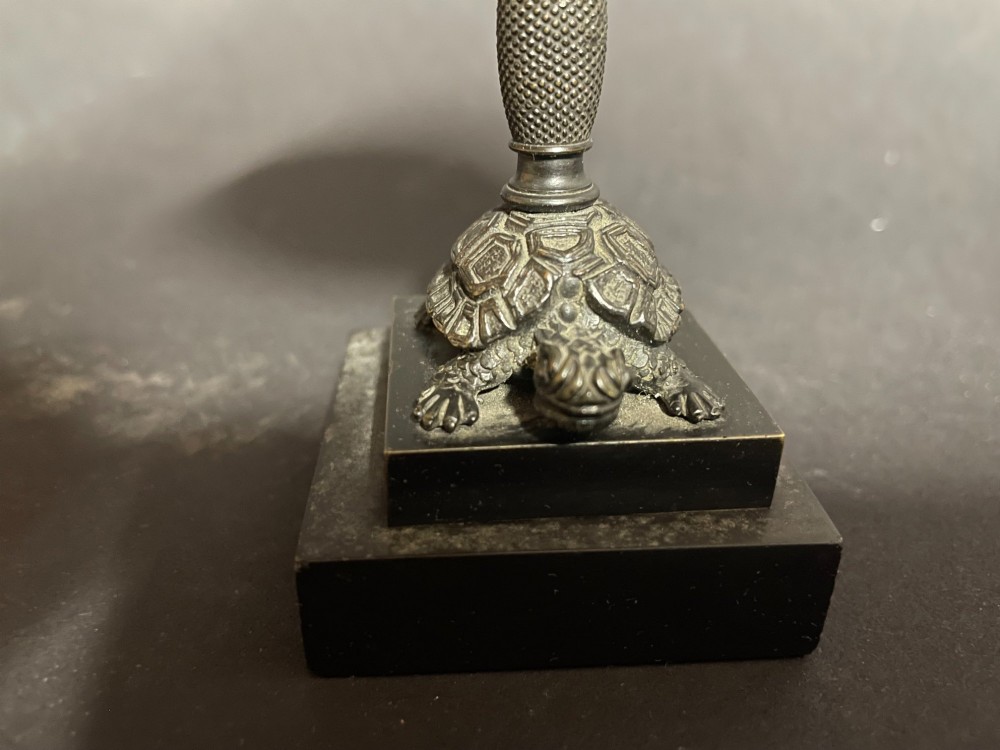 A carved coconut shell standing cup mounted on a bronze tortoise pedestal with a square stone base. View II