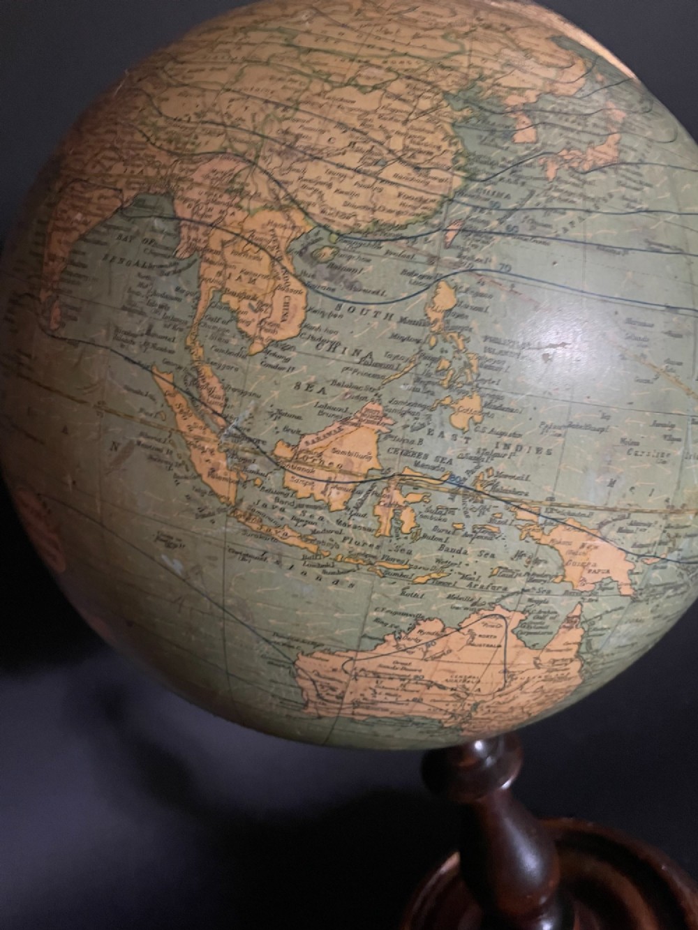 An antique terrestrial table globe mounted on a turned dark wood stand with a brass semi-meridian. View VI