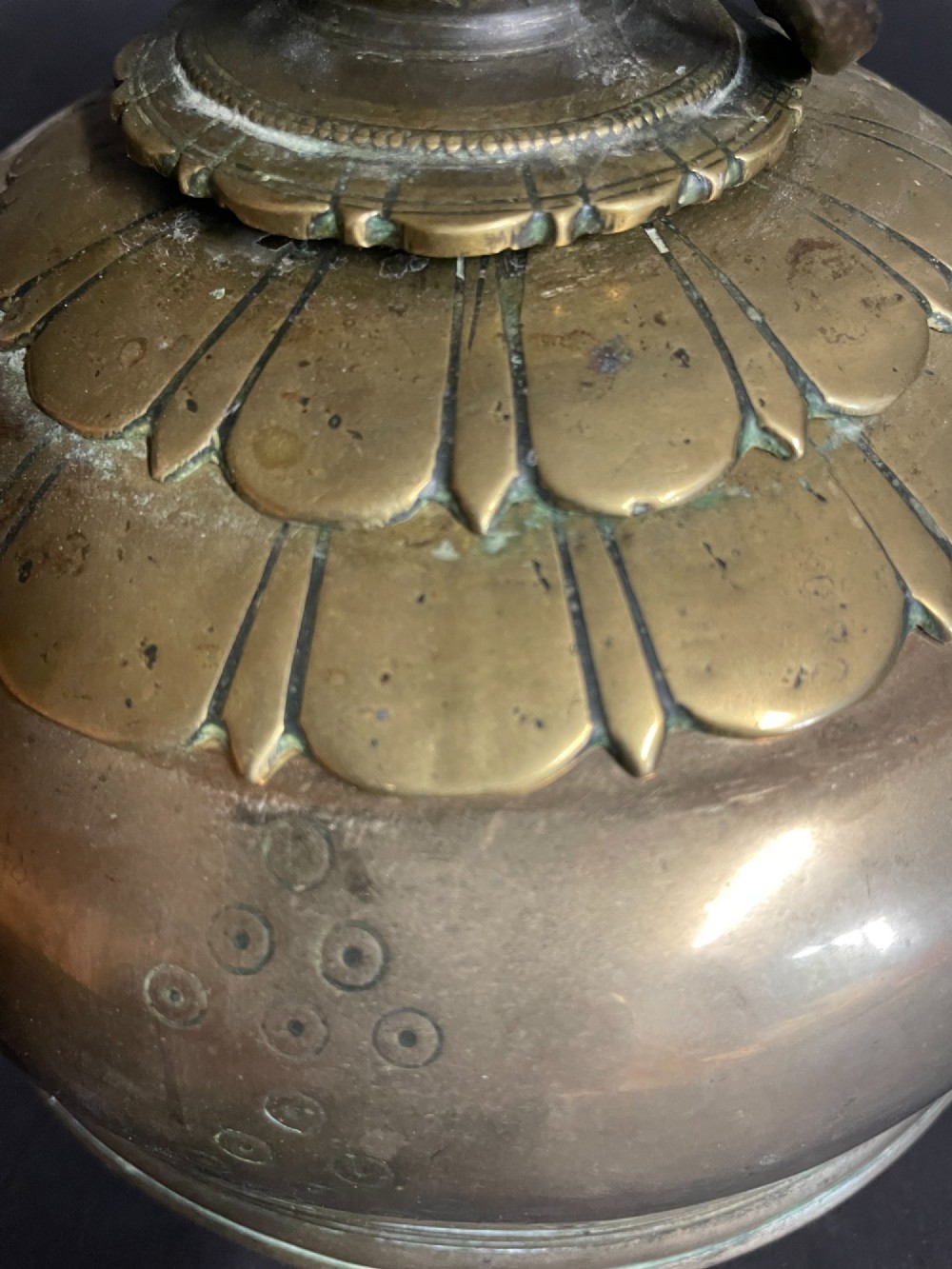 A dome-shaped Sino-Tibetan bronze bell featuring relief lotus petal decoration at the top collar and an iron attachment ring. View III
