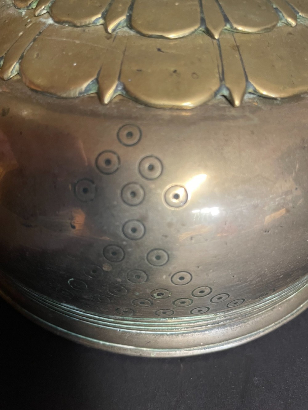 A dome-shaped Sino-Tibetan bronze bell featuring relief lotus petal decoration at the top collar and an iron attachment ring. View IV