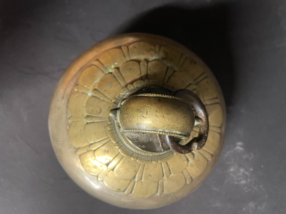 A dome-shaped Sino-Tibetan bronze bell featuring relief lotus petal decoration at the top collar and an iron attachment ring. View VII