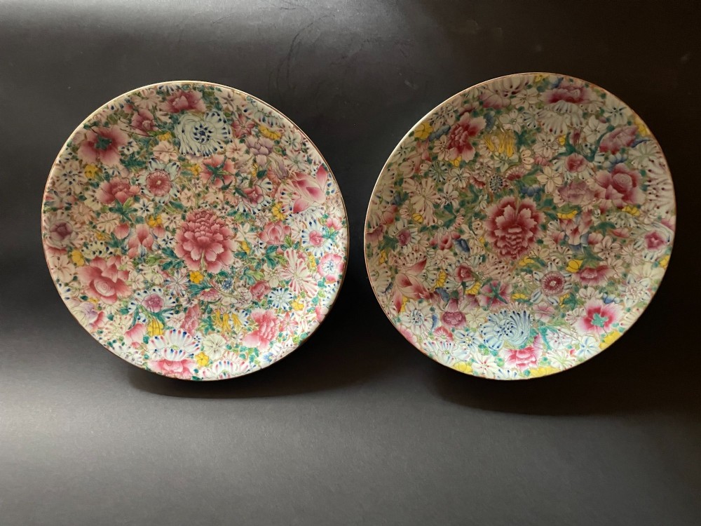 A pair of shallow circular Chinese porcelain dishes decorated with a dense all-over floral Millefleurs pattern in pink, green, yellow, and blue overglaze enamels.