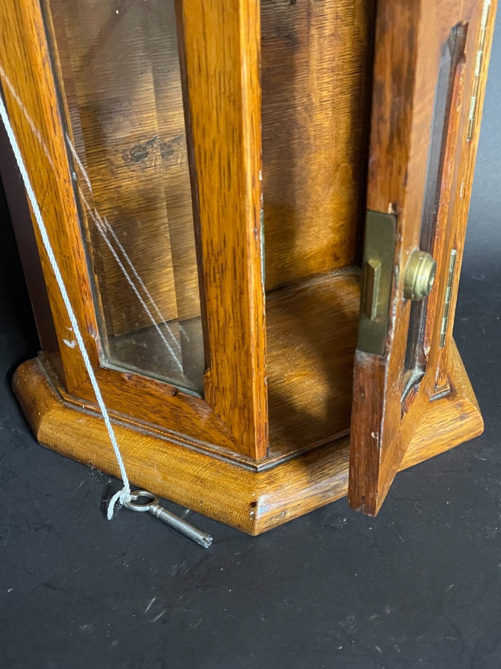 A Victorian oak tabletop letter box featuring brass fittings, a sloped aperture slot, glass side panels, and an arched brass top plate stamped LETTER BOX. View VI