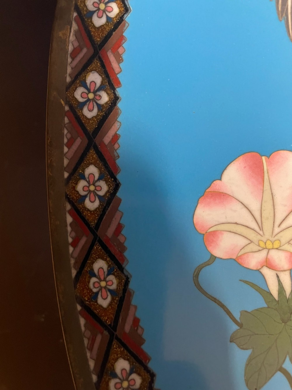 A circular Japanese cloisonne enamel charger depicting quails among chrysanthemums and lilies against a sky blue background with a patterned geometric border. View VI
