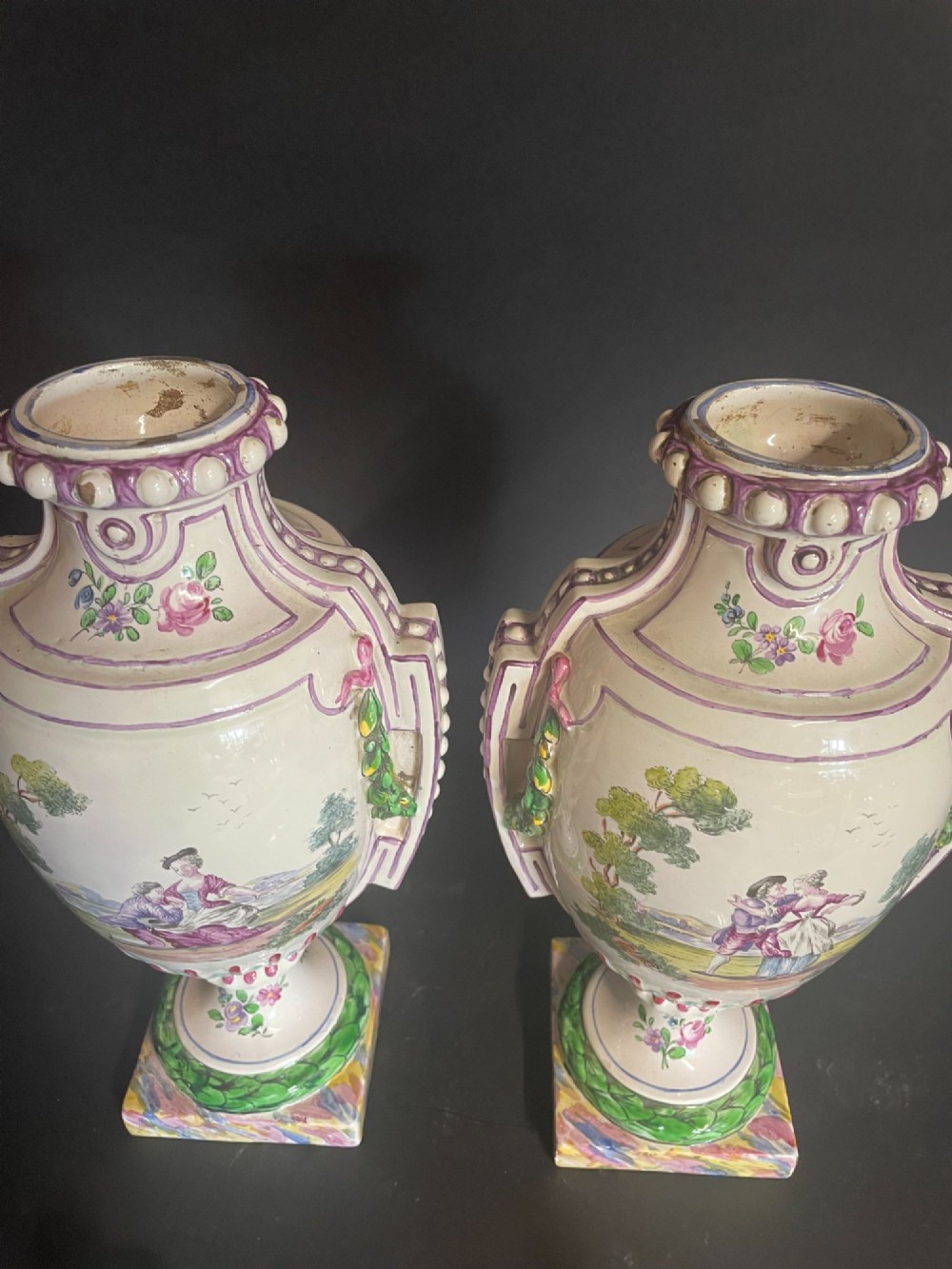 A pair of antique French Sceaux faience lidded urns decorated with hand-painted pastoral scenes, floral garlands, and moulding on square bases. View IV