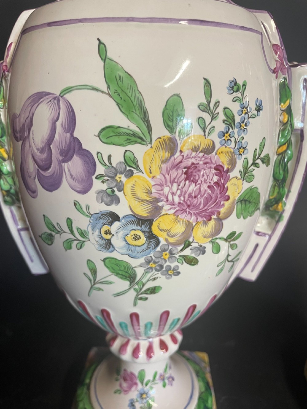 A pair of antique French Sceaux faience lidded urns decorated with hand-painted pastoral scenes, floral garlands, and moulding on square bases. View VII