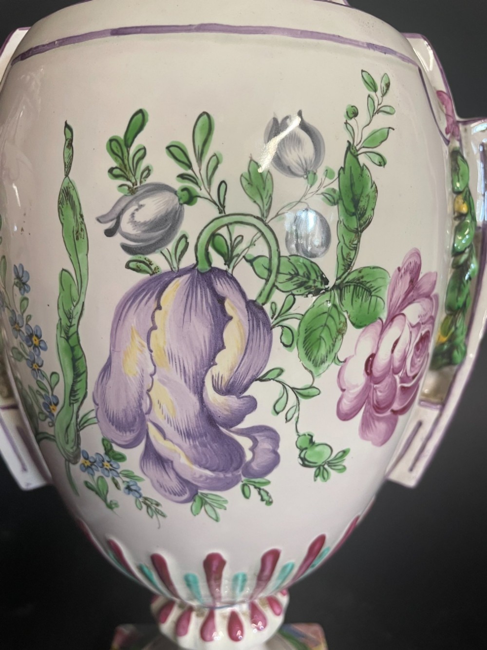 A pair of antique French Sceaux faience lidded urns decorated with hand-painted pastoral scenes, floral garlands, and moulding on square bases. View VIII