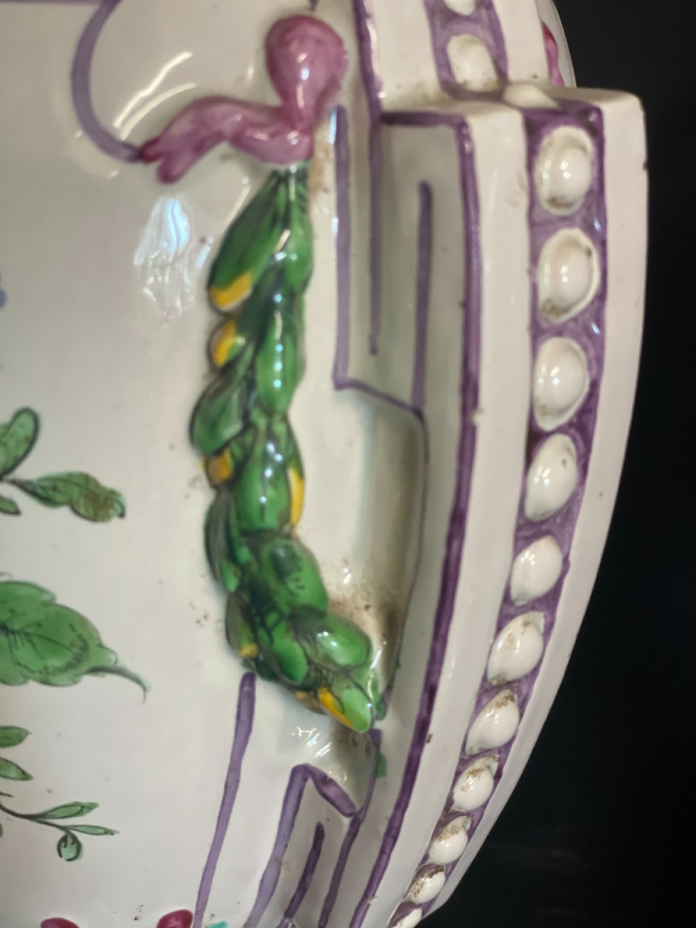 A pair of antique French Sceaux faience lidded urns decorated with hand-painted pastoral scenes, floral garlands, and moulding on square bases. View XII