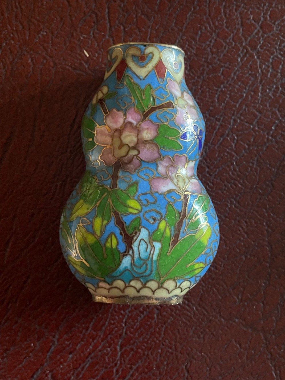 A miniature Chinese cloisonne double-gourd vase featuring turquoise blue enamel decorated with pink plum blossom motifs and gilt wirework. View II