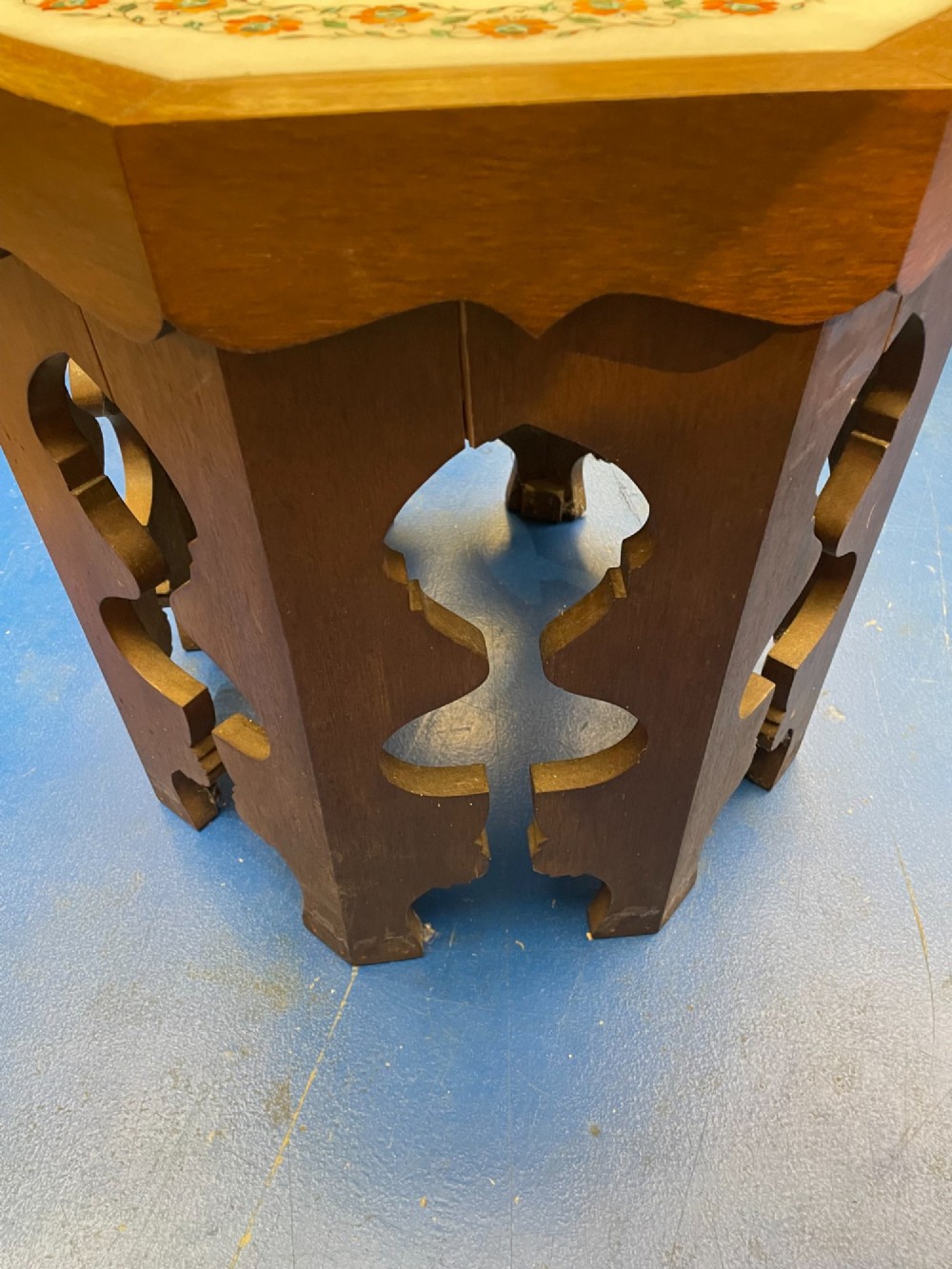 An octagonal wooden side table featuring a white marble top with floral stone inlay and a pierced carved wooden base. View III