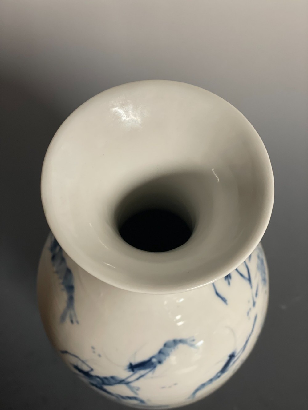 A tall white porcelain vase with a flared rim, featuring hand-painted cobalt blue shrimp motifs around the body. View VIII