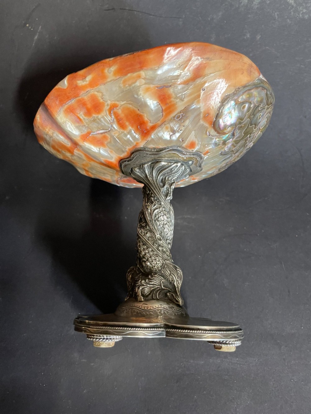 An antique abalone shell dish mounted on a relief-carved silvered metal pedestal with a lobed base. View VI
