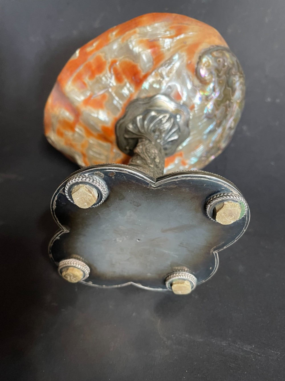 An antique abalone shell dish mounted on a relief-carved silvered metal pedestal with a lobed base. View IX