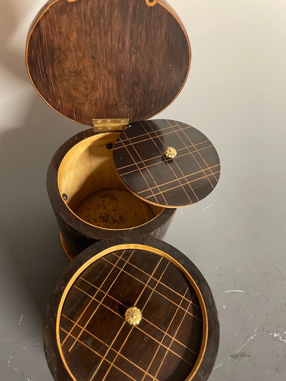 A dark brown wooden double cylindrical tea caddy featuring geometric line inlay and detailed figural marquetry scenes on the lids. View IX