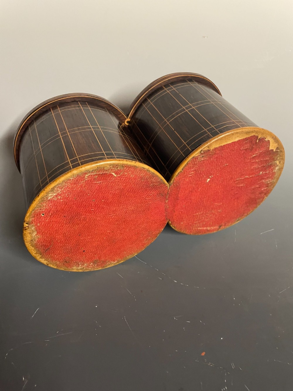 A dark brown wooden double cylindrical tea caddy featuring geometric line inlay and detailed figural marquetry scenes on the lids. View XI