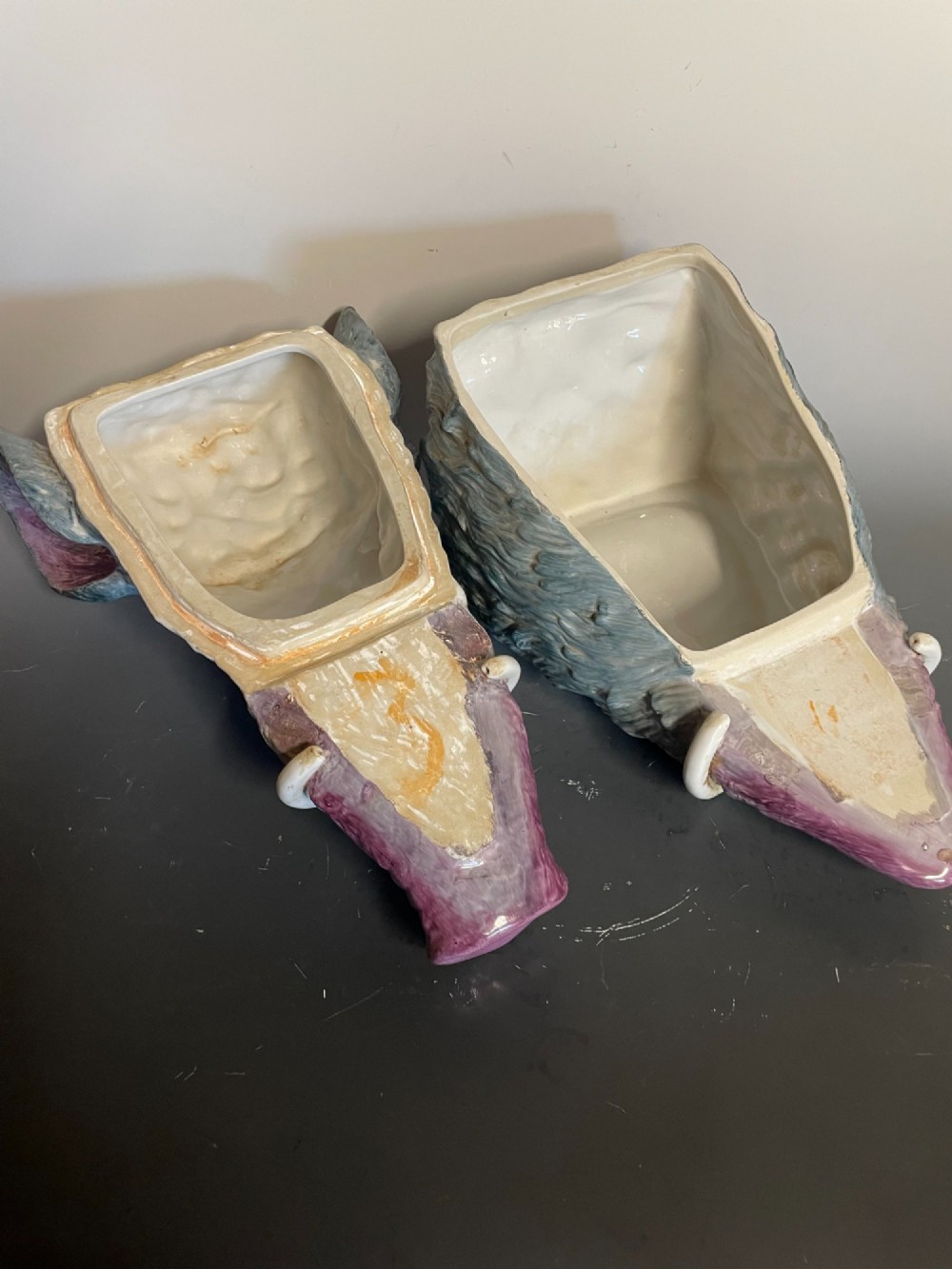 A glazed ceramic majolica tureen sculpted in the shape of a boars head with grey textured fur, pink snout, and white tusks. View VI