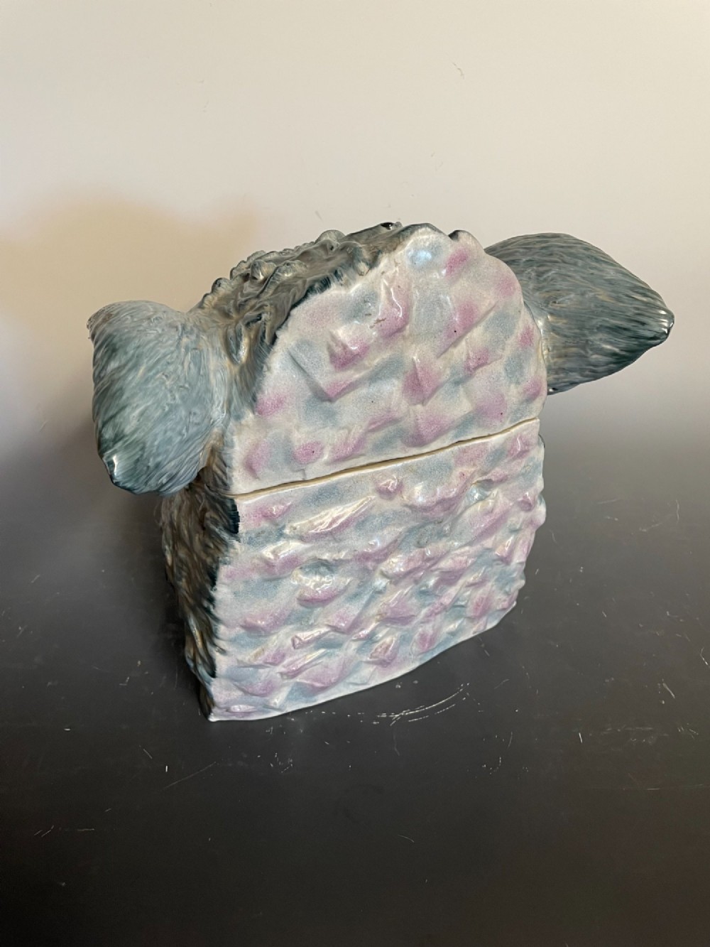 A glazed ceramic majolica tureen sculpted in the shape of a boars head with grey textured fur, pink snout, and white tusks. View VIII
