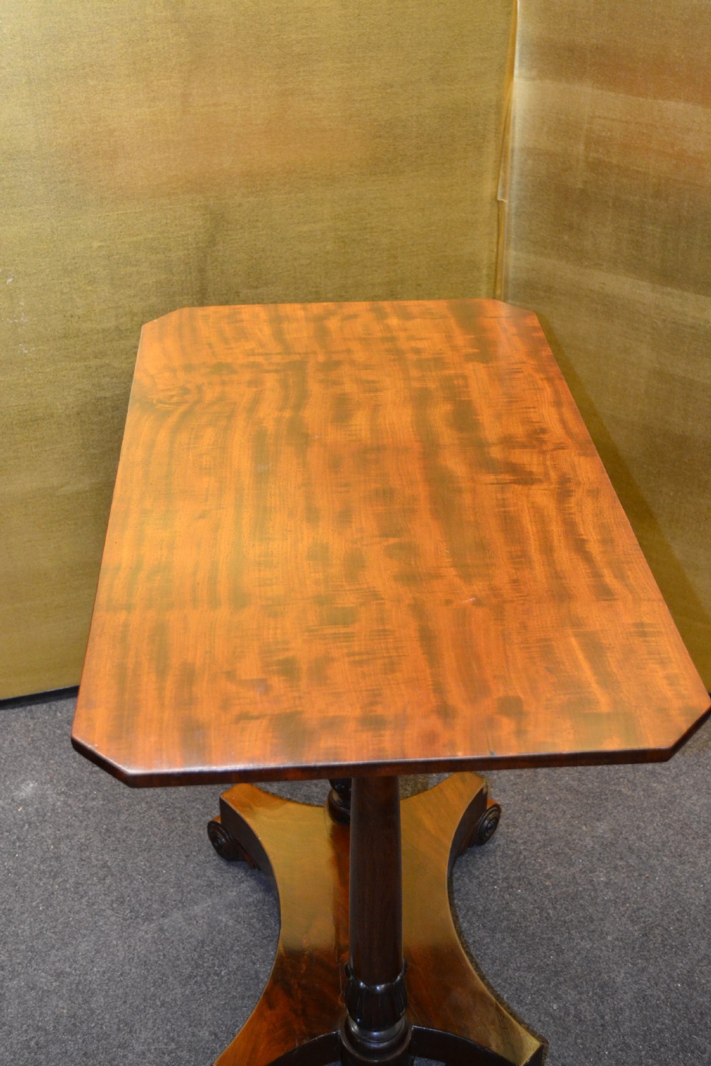 A William IV mahogany side table featuring carved scroll brackets, twin turned column supports, and a shaped plinth base on scroll feet. View VII