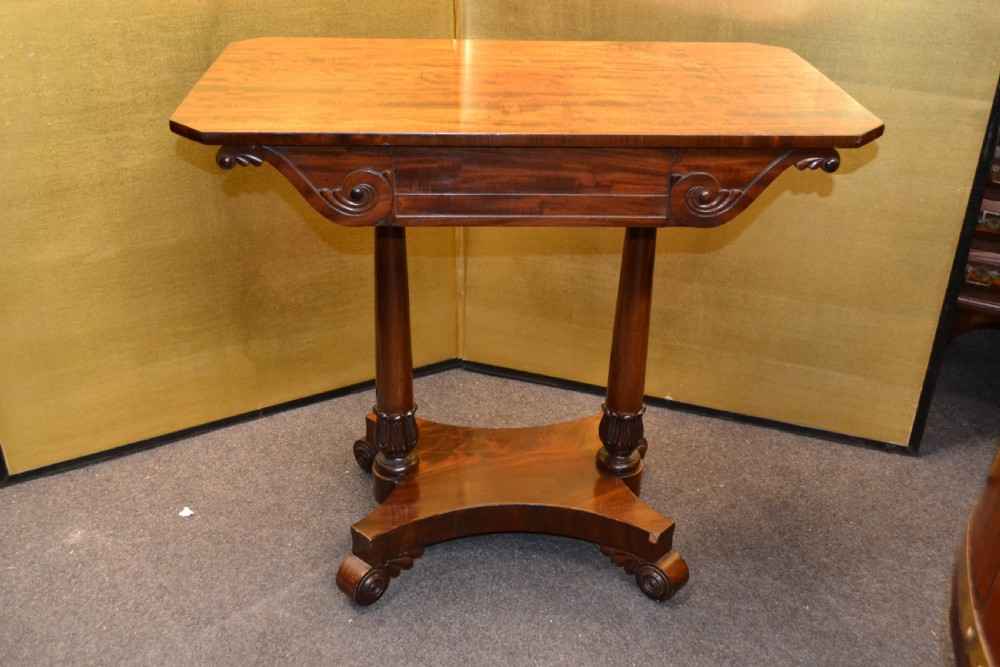 A William IV mahogany side table featuring carved scroll brackets, twin turned column supports, and a shaped plinth base on scroll feet. View VIII