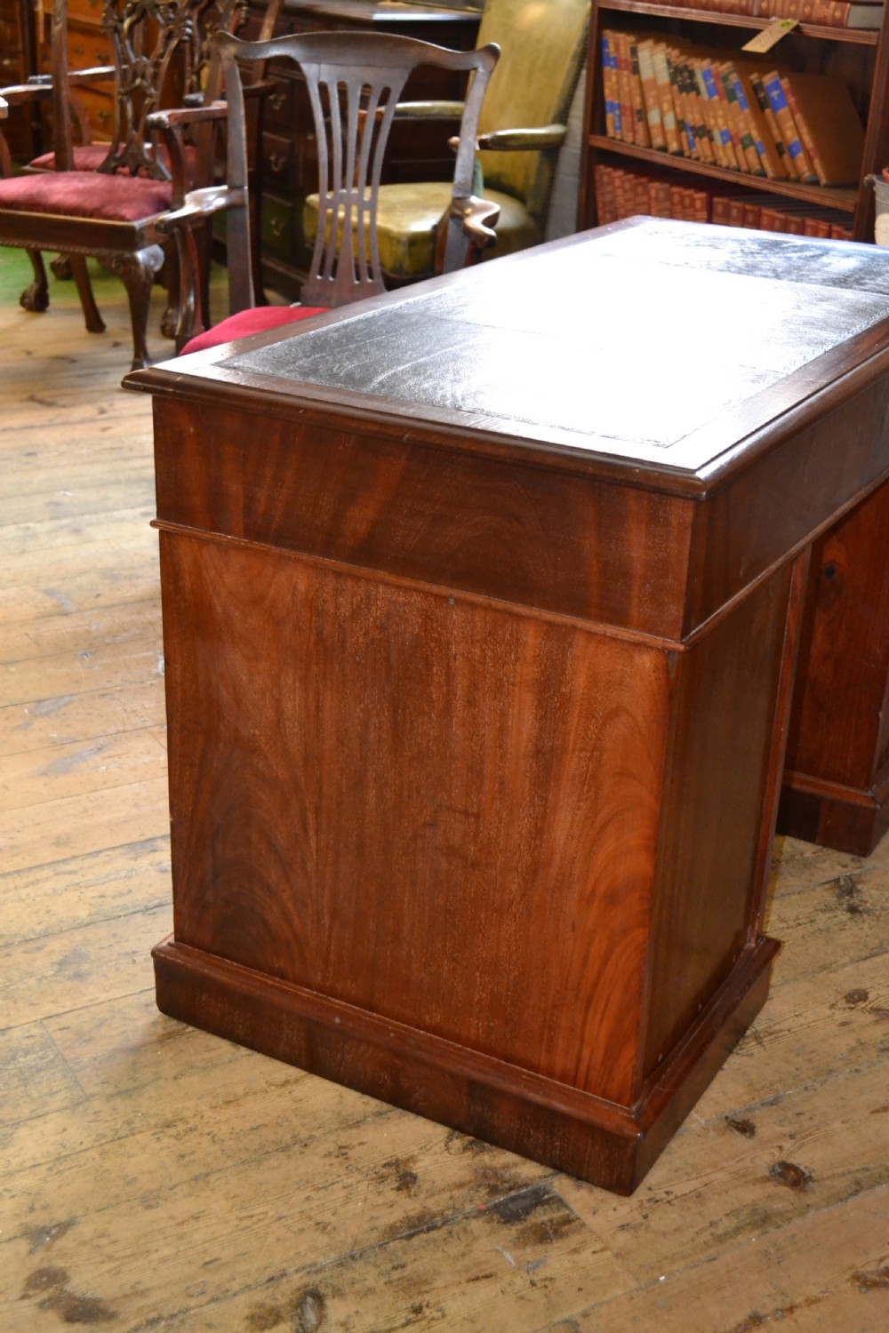 A Victorian walnut pedestal desk featuring nine drawers with brass handles and a dark leather writing insert. View VII