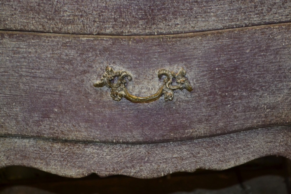 A small French-style three-drawer commode with a distressed grey paint finish, curved cabriole legs, decorative brass handles, and a veined marble top. View IV