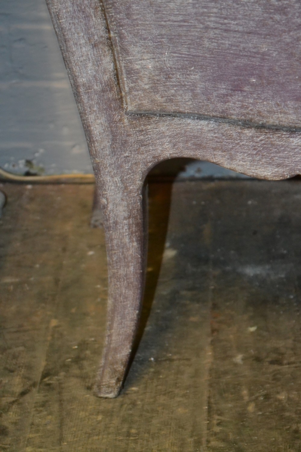 A small French-style three-drawer commode with a distressed grey paint finish, curved cabriole legs, decorative brass handles, and a veined marble top. View VI