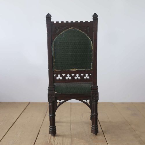 A pair of 19th-century Gothic Revival side chairs crafted from dark carved wood with dark green upholstered seats and backrests featuring pointed arch motifs. View VI