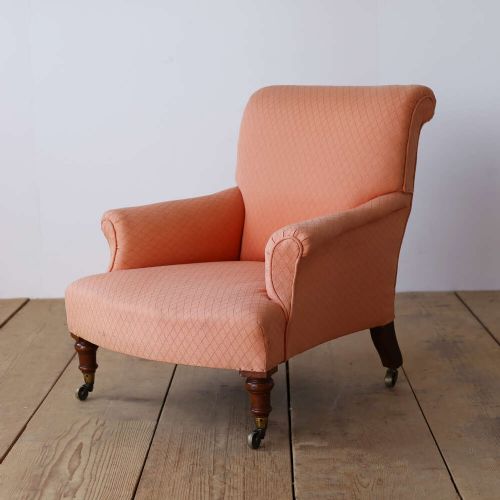 A pair of 19th-century upholstered armchairs in peach woven fabric featuring turned mahogany front legs with brass castors. View III